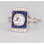 An 18ct white gold Art Deco style sapphire and diamond ring, the centre cushion cut diamond