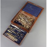 A 19th Century part geometry set contained in a mahogany case with hinged lid