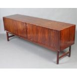 A mid 20th Century rosewood and oak sideboard, fitted 5 trays enclosed by a tambour shutter,