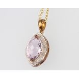 A 9ct yellow gold amethyst and diamond pendant on a ditto 44cm chain, 6.3 grams gross