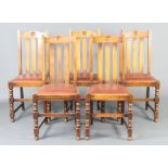 A set of 6 1930's oak stick and rail back dining chairs with arch shaped rail backs and
