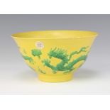 An 18th Century style Chinese yellow ground bowl decorated with green dragons chasing the flaming