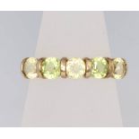 A 9ct yellow gold peridot 5 stone ring, size M, 2.1 grams
