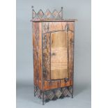 Valley Forge, a Zimbabwean hardwood and iron cabinet with castellated iron back, fitted shelves