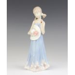 A Lladro figure of a young lady with a bonnet 5648 21cm
