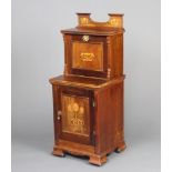 An Edwardian Art Nouveau inlaid mahogany coal purdonium with raised back, the upper section fitted a