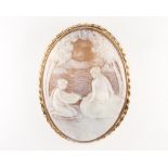 A large carved cameo brooch depicting two ladies beside a lake beneath trees, contained in a 9ct