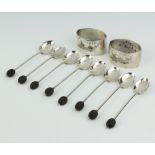A pair of Egyptian silver napkin rings and 8 silver bean end coffee spoons