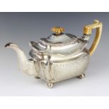 A George III Irish silver teapot with engraved decoration, raised on ball feet, Dublin 1813, gross