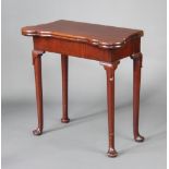 A Georgian shaped mahogany cantilever card table with baise top, fitted candle stands and game