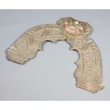 An "Indian" embossed metal door arch ornament, the top decorated a mask 60cm h x 51cm w Slight tears