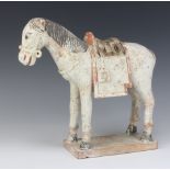 A 17th Century style Chinese unglazed figure of a horse raised on a rectangular base 25cm This