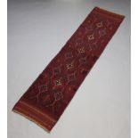 A red and blue ground Meshwani runner with 16 diamonds to the centre 248cm x 60cm