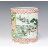 A Chinese famille verte cylindrical brush pot decorated with figures in landscapes 15cm