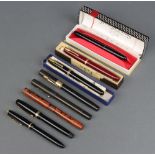 A black cased Swan Fountain pen boxed and 7 others