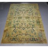 A pink and floral patterned Persian carpet with a 3 row border 303cm x 203cm Slight staining in