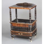 A Victorian aesthetic movement ebonised and walnut Canterbury with raised back, having bobbin turned