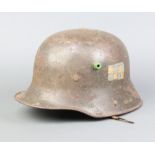 A German steel helmet marked T166 with part liner and no strap