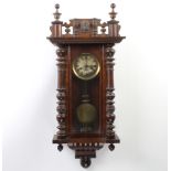A Vienna style striking regulator with silvered dial, Roman numerals, contained in a carved walnut