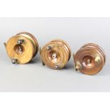 Three 19th Century wooden and brass star back centre pin fishing reels 11cm, 10cm and 10cm