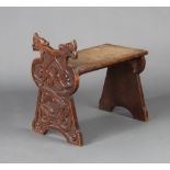 A Victorian carved oak stool with griffin decoration 45cm h x 47cm x 26cm Some light water marks