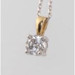 An 18ct yellow gold single stone diamond pendant, approx 0.5ct on an 18ct white gold 40cm chain