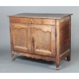 An 18th Century Continental oak cabinet fitted a drawer above a cupboard, raised on shaped
