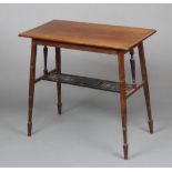 A rectangular Edwardian mahogany side table raised on square outswept supports with pierced