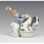 A Lladro group of a girl washing a hound in a barrel 5455 13cm