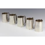 A set of 5 matched silver mugs with presentation inscriptions 770 gramsThe hallmarks are rubbed