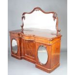 A Victorian mahogany sideboard with shaped mirrored back, the top of serpentine outline fitted