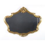 A shaped plate wall mirror contained in a decorative gilt frame 70cm h x 90cm w