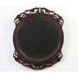 A Victorian circular bevelled plate wall mirror contained in a pierced mahogany frame 38cm diam.