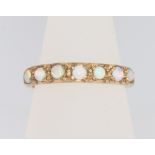 A 9ct yellow gold 7 stone opal ring, size O, 2.4 grams