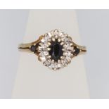 A 9ct yellow gold oval sapphire and diamond cluster ring, size N, 2.7 grams