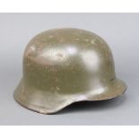 A German steel helmet complete with liner interior marked 64