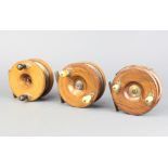 Three 19th Century wooden and brass star back fishing reels, 1 marked Fields Fishing Tackle, both