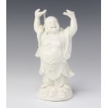 A blanc de chine figure of Hotei holding his hands aloft 18cm