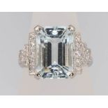 An Art Deco style platinum aquamarine and diamond ring, the centre stone approx. 9ct flanked by