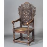 A Victorian carved oak Wainscot chair, the arched crest marked Dred God, raised on turned and