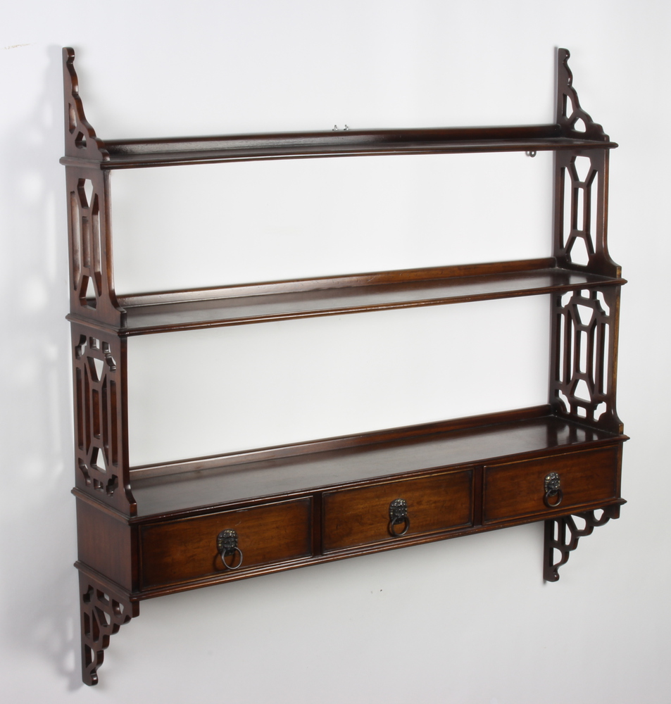 A pair of Georgian style mahogany 3 tier wall shelves with pierced panels to the side, the base