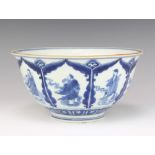 An 18th Century style Chinese blue and white bowl decorated with panels of figures bearing a 6