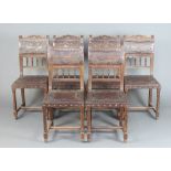 A set of 6 19th Century Carolean style carved oak and leather dining chairs, the seats and backs