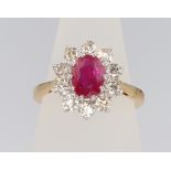 An 18ct yellow gold oval ruby and diamond ring, the centre stone 1.5ct the diamonds approx. 1ct,