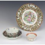 An 18th Century Chinese tea bowl and saucer decorated with flowers, a tea bowl decorated with
