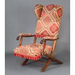 An Edwardian mahogany folding wing framed campaign chair