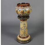 A Doulton Lambeth jardiniere stand decorated with stylised flowers 75cm together with a Doulton