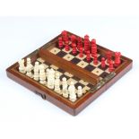 A 19th Century inlaid mahogany travelling chess set with turned ivory pieces (1 red bishop missing)