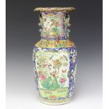 A 19th Century famille rose oviform vase decorated with panels of birds and insects having lion
