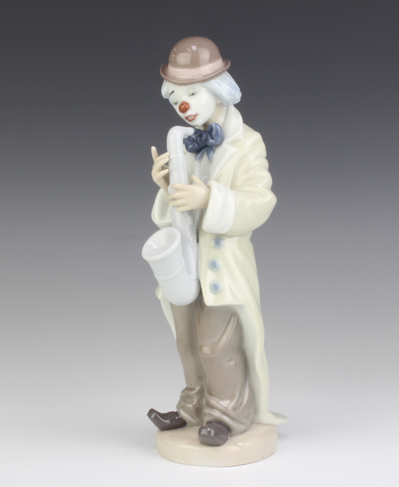 A Lladro figure of a clown playing a saxophone 5471 22cm